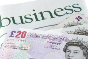 Business section of a newspaper and British pounds sterling